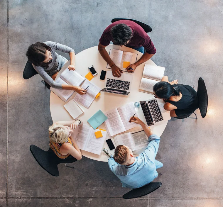 group of people sitting at round table