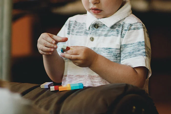 autistic child playing with legos