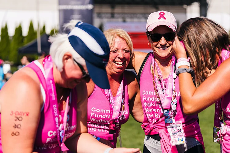 group of breast cancer runners celebrating in pink