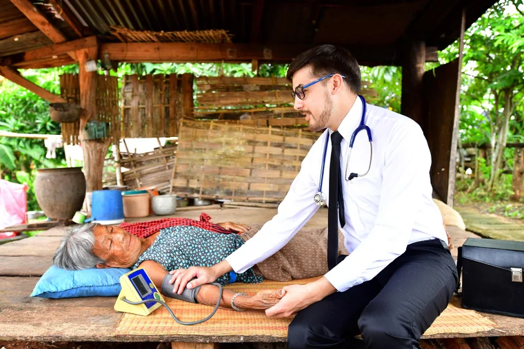 doctor helping woman globally