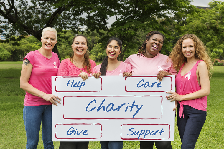 group of breast cancer supporters holding sign