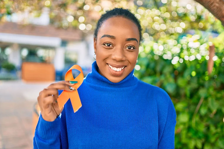woman holding a ms awareness ribbon