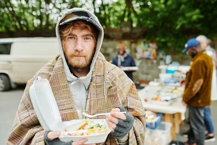 homeless man eating food