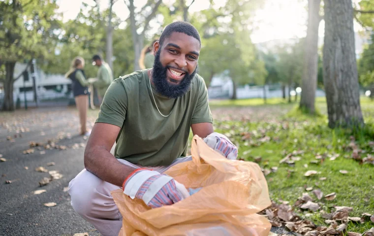man helping pick up trash