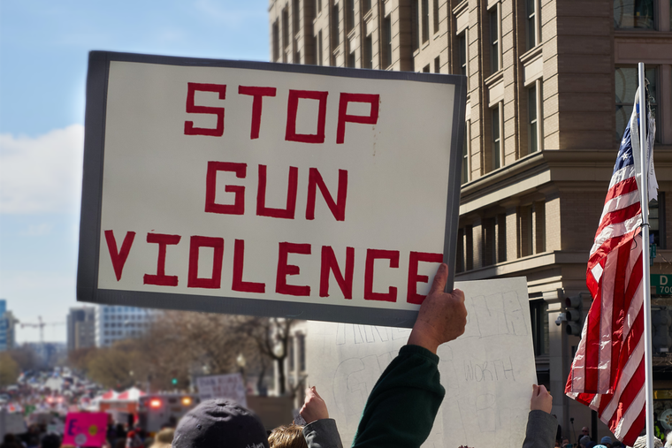 protestor holding stop gun violence sign