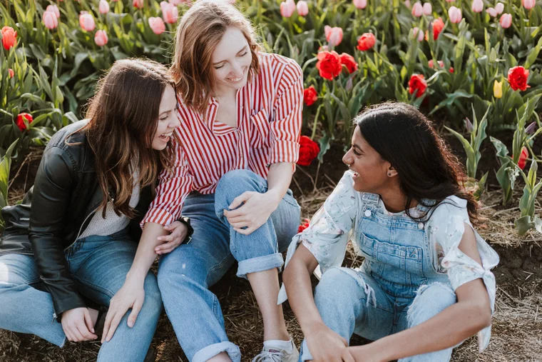 three women in a field of tulips